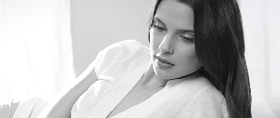 Woman with dark hair in a relaxed pose