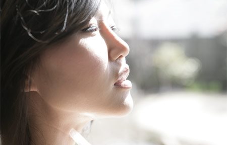 Asian woman looking in the sun