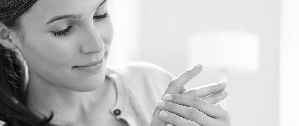 Woman applying cream on her hands