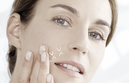 Woman uses concentrate between eyes