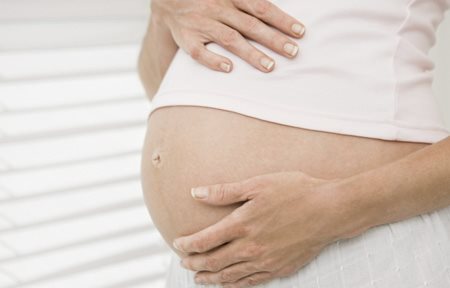 Pregnant woman holding her belly