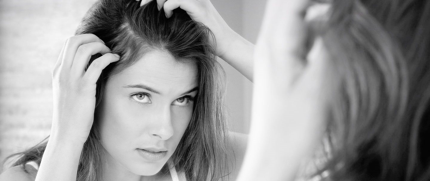 A woman checking for dandruff