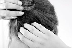 A woman scratching her itchy scalp