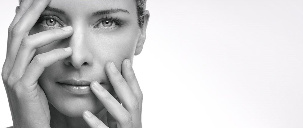 Woman using spot corrector on her left hand